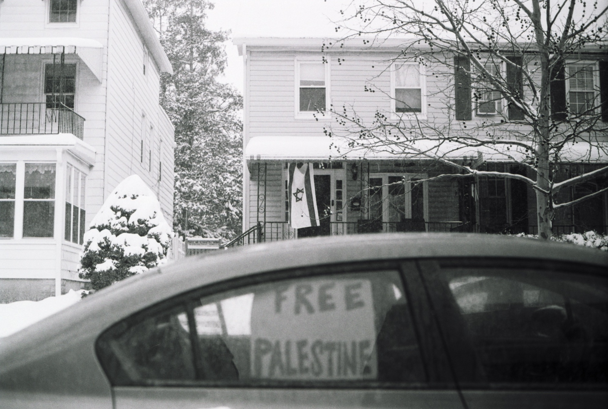 Israeli flag and Free Palestine cardboard sign